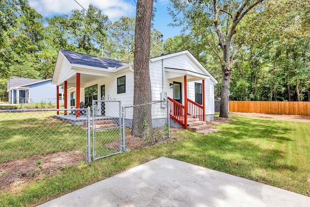 view of front of home featuring covered porch and a front yard