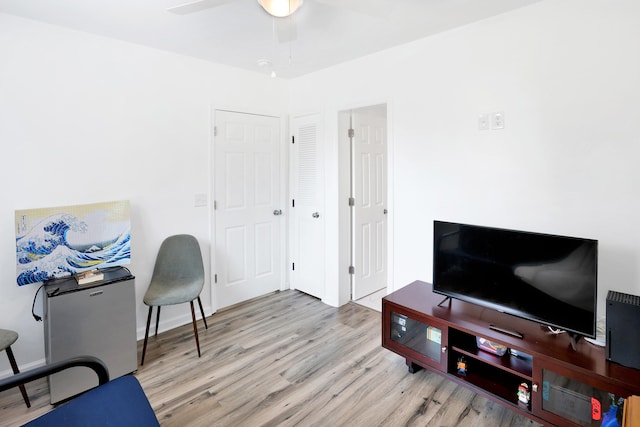 home office with ceiling fan and light hardwood / wood-style flooring