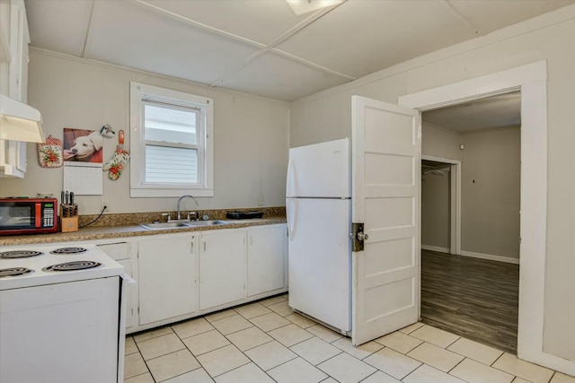 kitchen featuring white cabinets, light tile patterned floors, white appliances, and sink