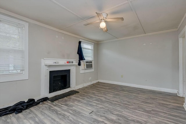 unfurnished living room featuring hardwood / wood-style floors, cooling unit, ceiling fan, and ornamental molding