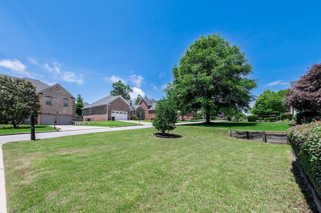 1217 Berkley Hills Pass, Evans, GA 30809 - view of grassy yard with a residential view, concrete driveway, and an attached garage