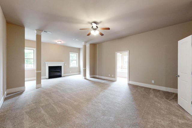 1217 Berkley Hills Pass, Evans, GA 30809 - unfurnished living room featuring a ceiling fan, light carpet, ornate columns, baseboards, and a fireplace with flush hearth