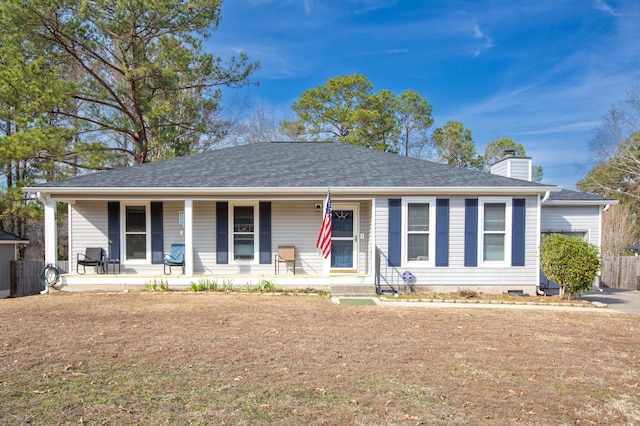 ranch-style house featuring a porch and a front yard