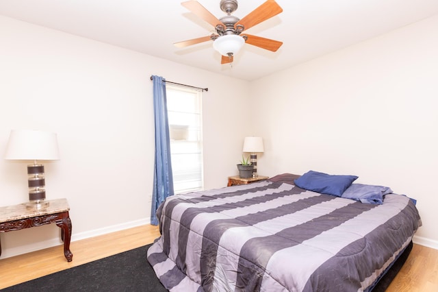 bedroom with ceiling fan and light wood-type flooring