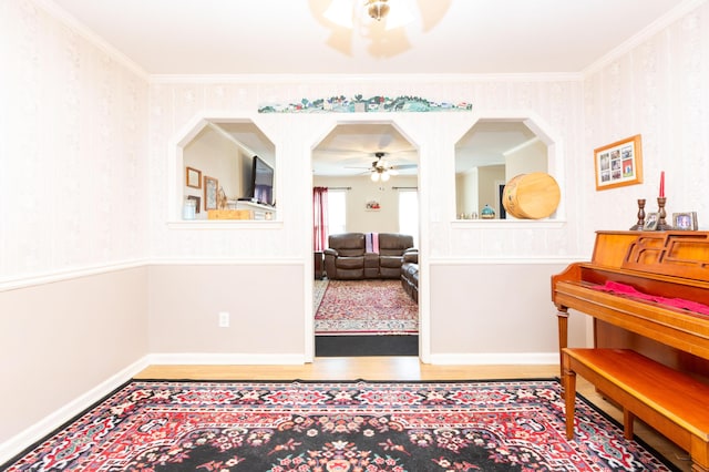 interior space featuring ornamental molding, ceiling fan, and light hardwood / wood-style floors