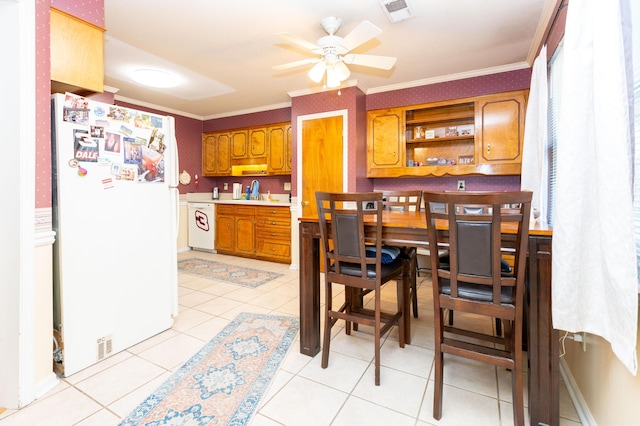 kitchen with light tile patterned floors, white appliances, ornamental molding, and ceiling fan