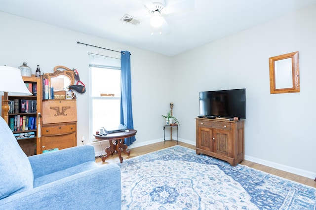 living room with hardwood / wood-style flooring and ceiling fan