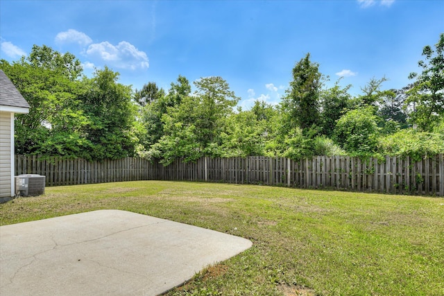 view of yard featuring a fenced backyard, a patio area, and central AC