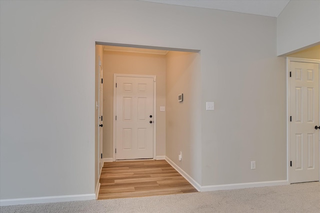 interior space with baseboards and light colored carpet
