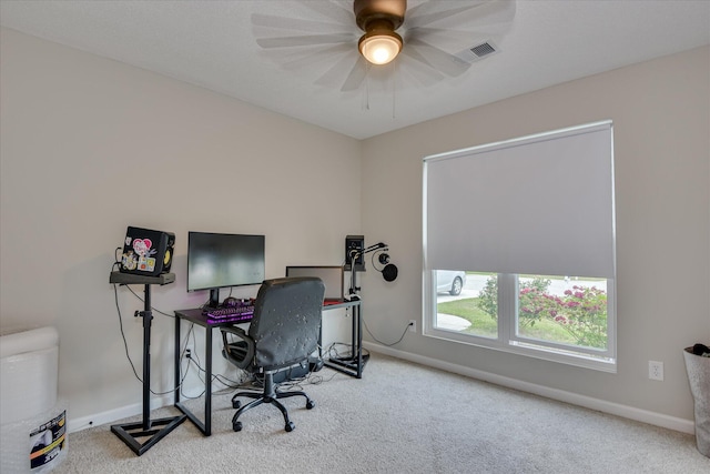 carpeted office with baseboards, a ceiling fan, and visible vents