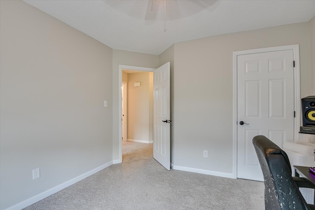 office featuring carpet floors, baseboards, and ceiling fan