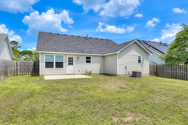 back of house featuring a fenced backyard, a patio area, central air condition unit, and a yard