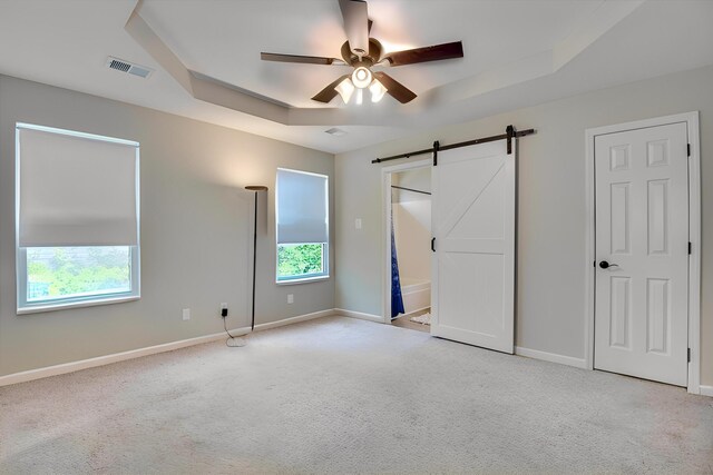 610 Creek Bottom Trl, Grovetown, GA 30813 - unfurnished bedroom with carpet floors, baseboards, a barn door, and visible vents
