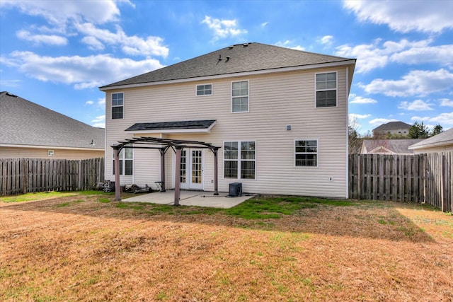 rear view of house featuring a yard, a patio area, a fenced backyard, and a pergola