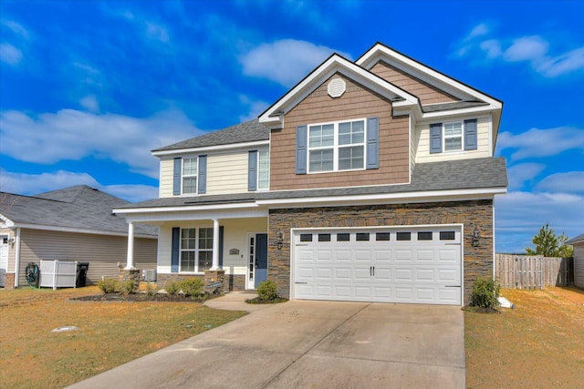 view of front of home featuring a front yard, fence, driveway, a porch, and a garage