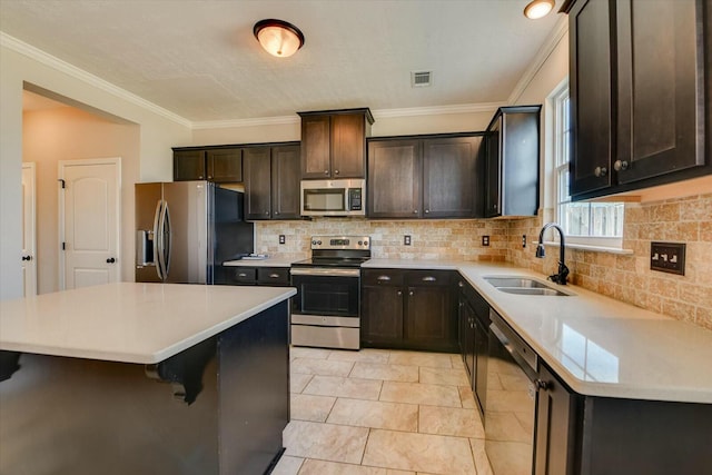 kitchen with light countertops, visible vents, appliances with stainless steel finishes, a sink, and a kitchen island