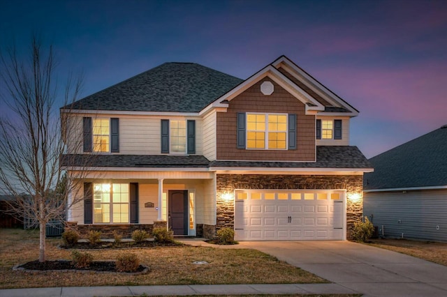 craftsman inspired home with an attached garage, stone siding, driveway, and roof with shingles