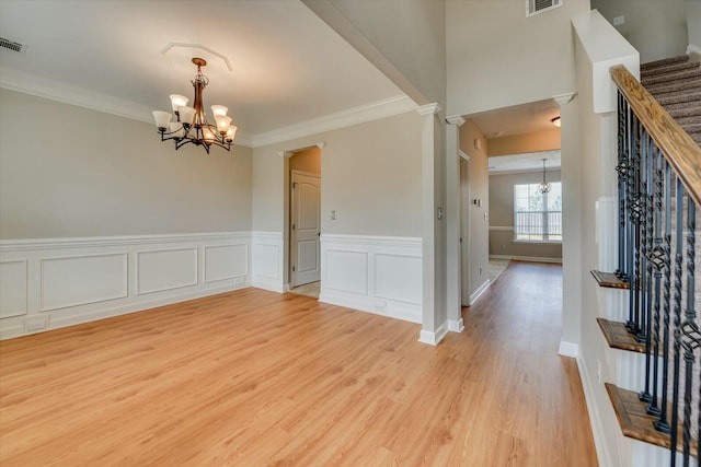 interior space with visible vents, stairway, a notable chandelier, and wood finished floors