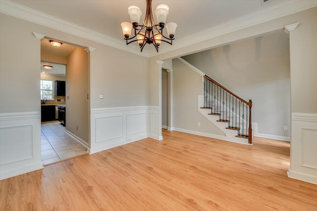7050 Summerton Dr, Augusta, GA 30909 - interior space featuring a wainscoted wall, stairway, crown molding, light wood finished floors, and a chandelier