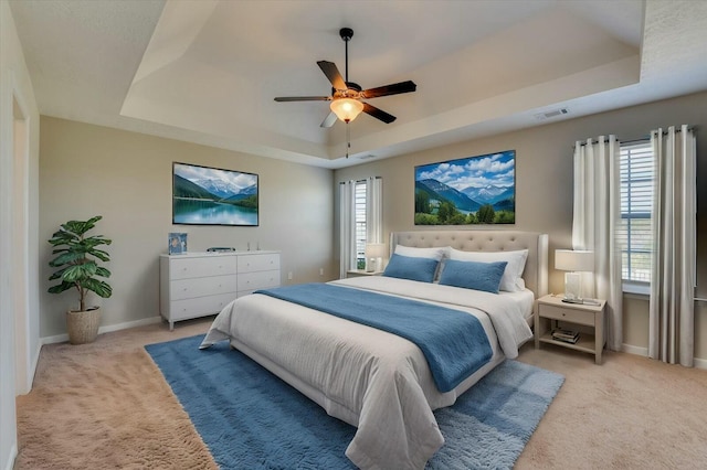 7050 Summerton Dr, Augusta, GA 30909 - carpeted bedroom with a tray ceiling, baseboards, visible vents, and ceiling fan
