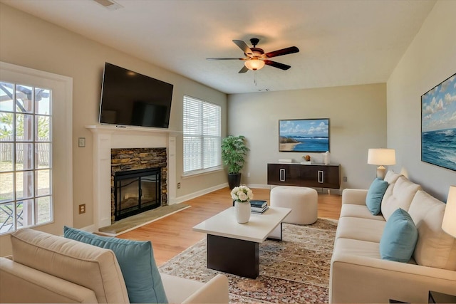 7050 Summerton Dr, Augusta, GA 30909 - living area with light wood finished floors, a stone fireplace, baseboards, and ceiling fan