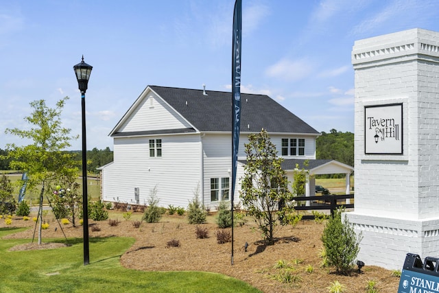 back of property featuring a yard