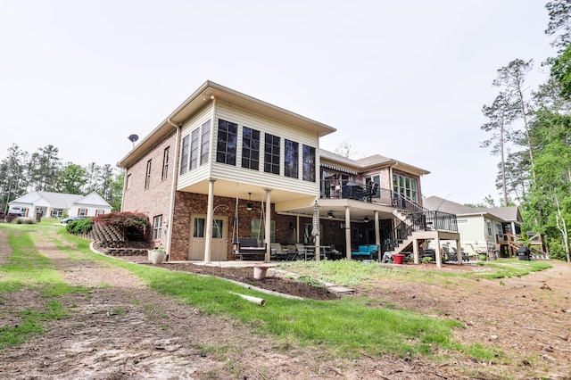 148 Grandview Dr, Mccormick, SC 29835 - back of house featuring brick siding, a ceiling fan, a sunroom, and stairway