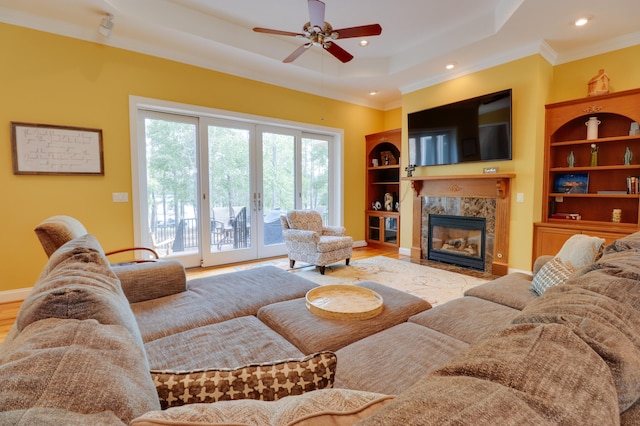148 Grandview Dr, Mccormick, SC 29835 - living area with built in shelves, a premium fireplace, ceiling fan, crown molding, and a raised ceiling