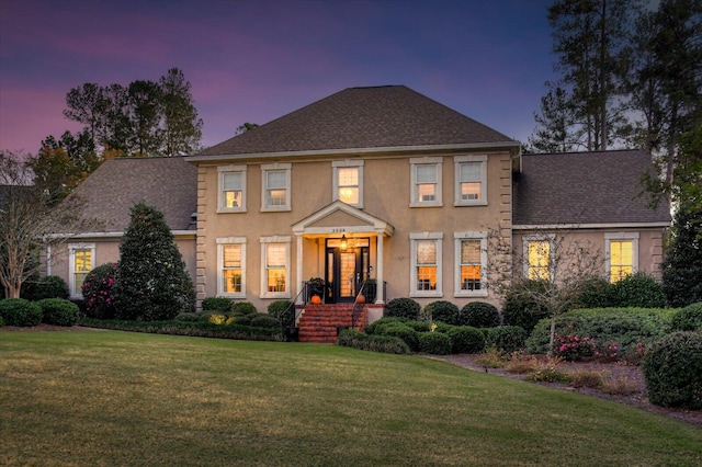 colonial home with a lawn