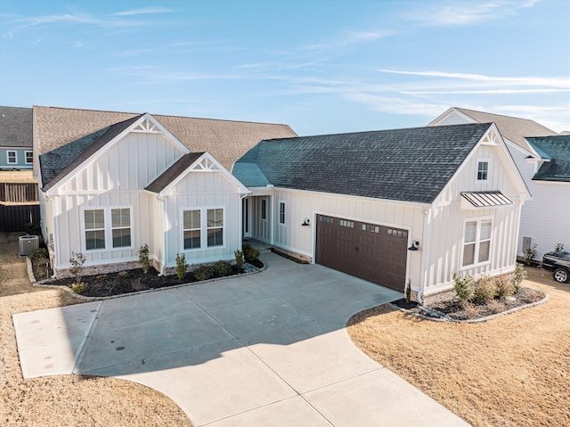 modern farmhouse style home with central air condition unit, driveway, roof with shingles, board and batten siding, and a garage