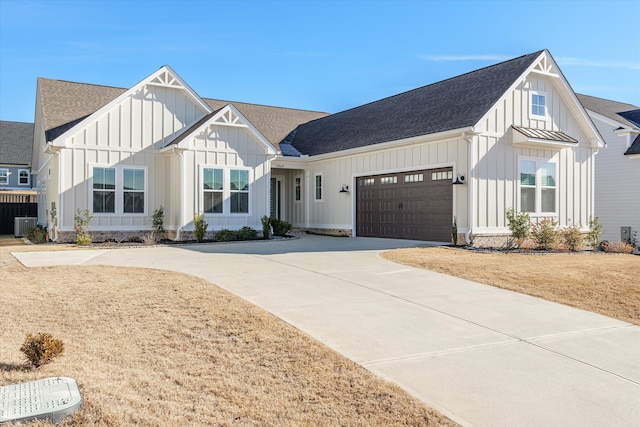 modern inspired farmhouse with cooling unit, roof with shingles, concrete driveway, a garage, and board and batten siding