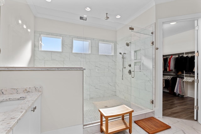 full bathroom with a spacious closet, recessed lighting, a stall shower, and crown molding