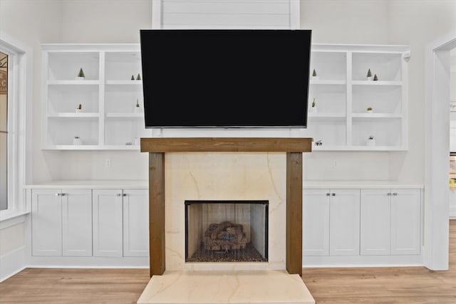 unfurnished living room featuring light wood-style floors and a fireplace