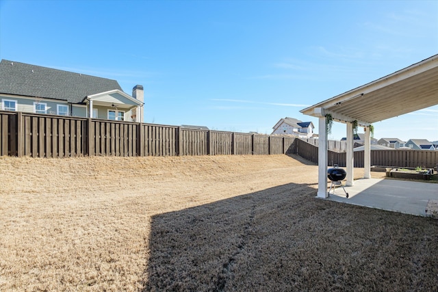 view of yard with a patio area and a fenced backyard