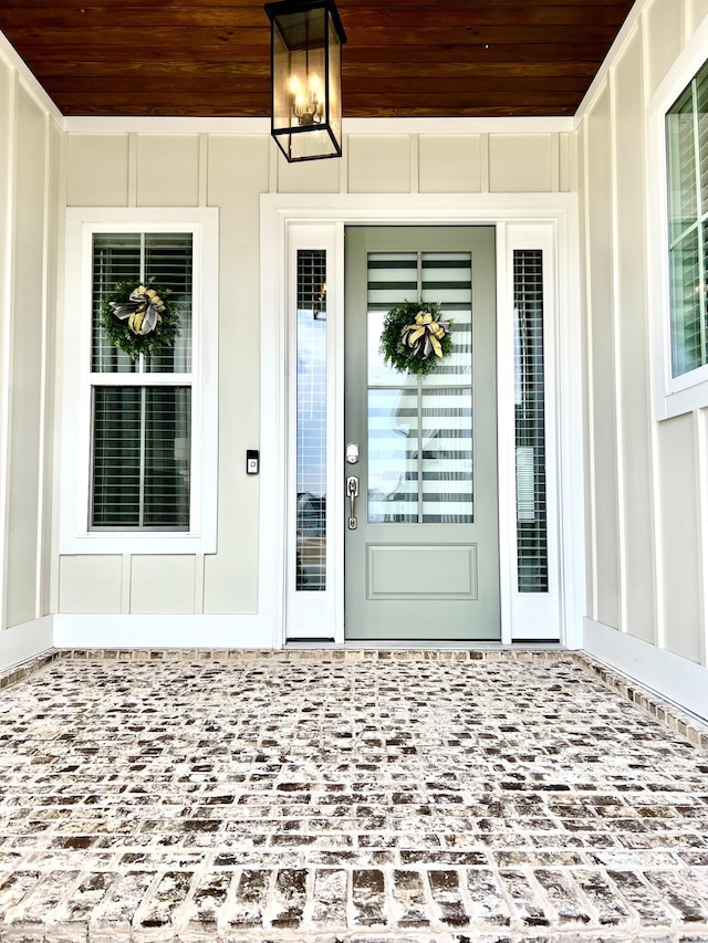 entrance to property with board and batten siding and covered porch