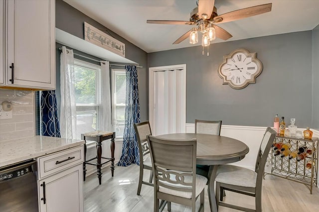 dining area with ceiling fan and light hardwood / wood-style flooring