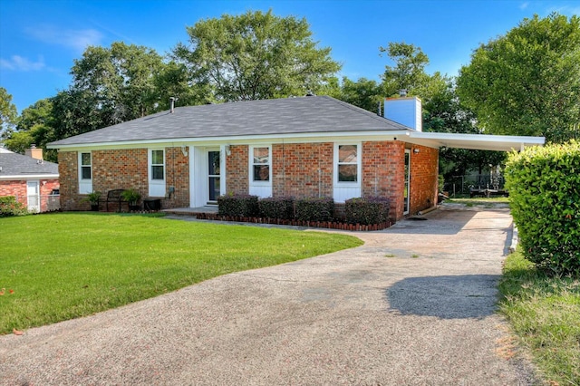 ranch-style house featuring a front lawn and a carport