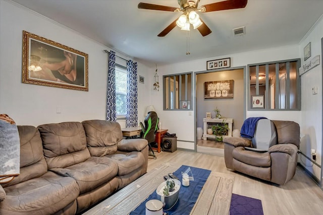 living room with light hardwood / wood-style floors and ceiling fan