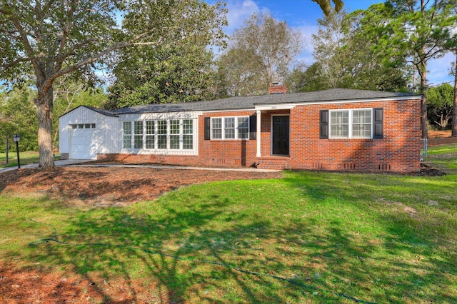 ranch-style house featuring a garage and a front lawn