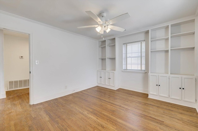 unfurnished room featuring ceiling fan, light hardwood / wood-style flooring, and ornamental molding