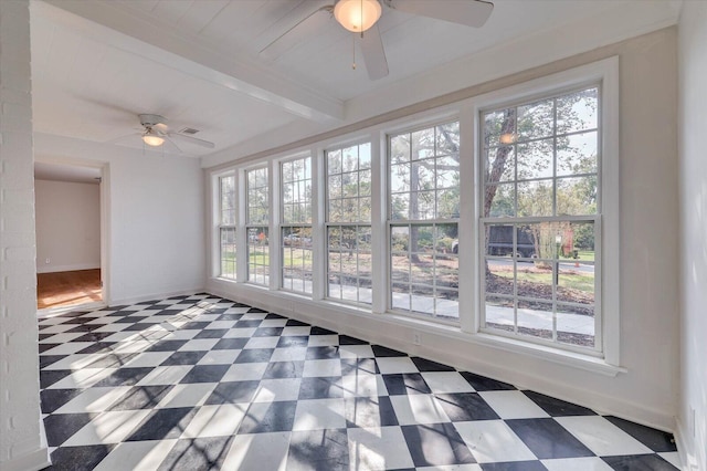 unfurnished sunroom with beam ceiling