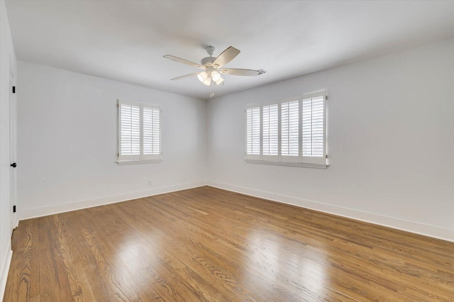 unfurnished room with ceiling fan, hardwood / wood-style floors, and a healthy amount of sunlight