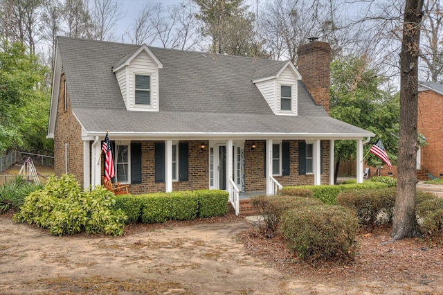 new england style home with covered porch