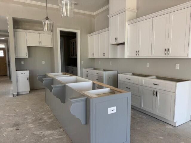 318 Holly Oak Way Unit Sc68, Grovetown, GA 30813 - kitchen featuring a kitchen island with sink, ornamental molding, white cabinets, pendant lighting, and unfinished concrete flooring