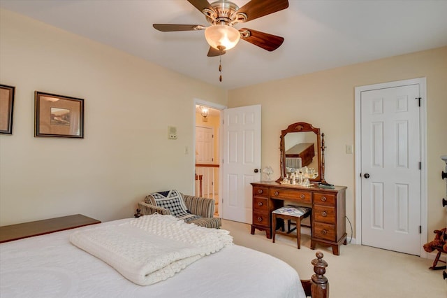bedroom with ceiling fan and light carpet