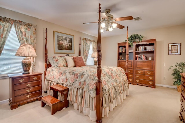 bedroom featuring light carpet, multiple windows, visible vents, and baseboards
