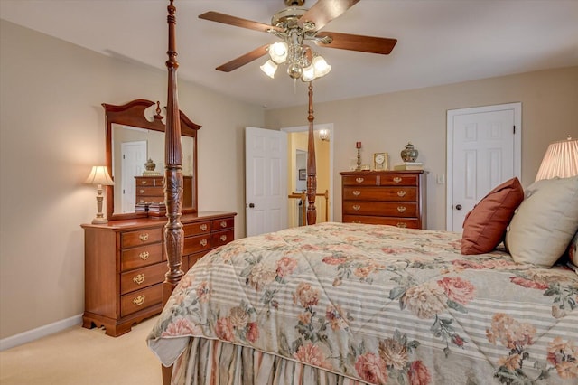 bedroom with light colored carpet, ceiling fan, and baseboards