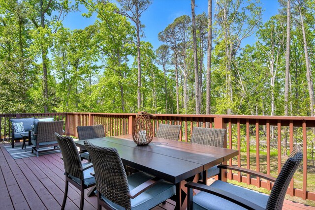 wooden terrace featuring an outdoor hangout area and outdoor dining space
