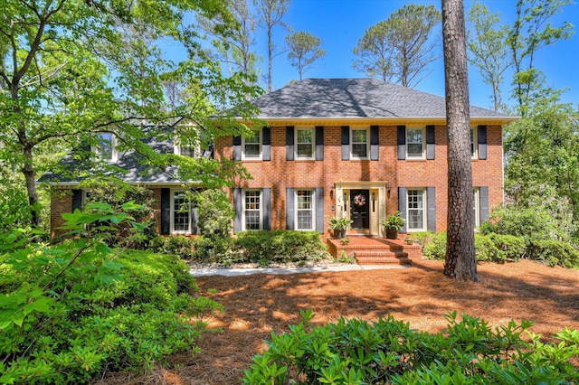 colonial home with brick siding