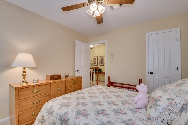 bedroom with baseboards, visible vents, and ceiling fan